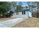 Newly renovated ranch home with gray siding, and a blue accented roof at 110 Hidden Brook Ct, Atlanta, GA 30349