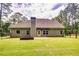 Large backyard with grassy lawn, raised garden bed, and privacy fence at 45 Knight Ln, Mcdonough, GA 30252