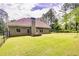 Large backyard with grassy lawn, raised garden bed, and privacy fence at 45 Knight Ln, Mcdonough, GA 30252