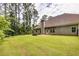 Large backyard with grassy lawn, raised garden bed, and privacy fence at 45 Knight Ln, Mcdonough, GA 30252