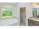 Bathroom with garden tub, separate toilet area, and double vanity at 45 Knight Ln, Mcdonough, GA 30252