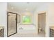 Bathroom with soaking tub, walk-in shower, and separate toilet area at 45 Knight Ln, Mcdonough, GA 30252