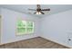 Spacious bedroom with ceiling fan and large window at 45 Knight Ln, Mcdonough, GA 30252