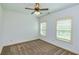 Bedroom with ceiling fan and two windows with blinds at 45 Knight Ln, Mcdonough, GA 30252