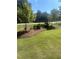 Neatly landscaped front yard with young trees and mulch at 45 Knight Ln, Mcdonough, GA 30252