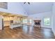 Open concept living area with hardwood floors, kitchen island, and stone fireplace at 45 Knight Ln, Mcdonough, GA 30252