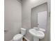 Powder room with pedestal sink and toilet at 623 Gabby Sw Pt, Mableton, GA 30126