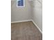 Walk-in closet with carpeted floor and hanging rods at 623 Gabby Sw Pt, Mableton, GA 30126