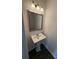 Small bathroom with pedestal sink and framed mirror at 2784 Lakeside Sw Dr, Conyers, GA 30094