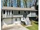 Gray two-story house with attached garage and deck at 3571 Quail Hollow Trl, Snellville, GA 30039