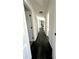 Long hallway with dark flooring leading to living space at 3571 Quail Hollow Trl, Snellville, GA 30039