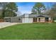 Ranch style home with carport, new roof, and landscaped lawn at 4166 Idlevale Dr, Tucker, GA 30084