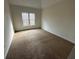 Spacious bedroom featuring neutral walls and wall-to-wall carpet at 212 Hailwood Ct, Suwanee, GA 30024