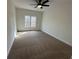 Well-lit bedroom featuring a large window and carpet at 212 Hailwood Ct, Suwanee, GA 30024