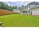 Large backyard with green lawn and retaining wall at 2201 E Maddox Rd, Buford, GA 30519