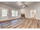 Spacious living room featuring hardwood floors, a stone fireplace, and large windows at 304 Old Yorkville Rd, Dallas, GA 30157