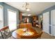 Bright dining room features a wood table, four chairs, and hardwood floors at 205 Landon Way, Covington, GA 30016