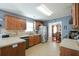 Kitchen with wood cabinets, stainless steel appliances, and tile floor at 205 Landon Way, Covington, GA 30016