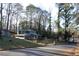 Two story house with green siding, nestled in wooded area at 1026 Valley View Rd, Atlanta, GA 30315