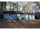 Ranch style home with blue siding, green door and mature trees at 1026 Valley View Rd, Atlanta, GA 30315