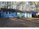 Blue house with a bright yellow door, surrounded by trees at 1026 Valley View Rd, Atlanta, GA 30315