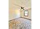 Simple bedroom with brown carpet, ceiling fan, and a window at 2931 Randolph Ne Ct, Conyers, GA 30012