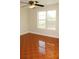 Well-lit bedroom with ceiling fan and wood-look tile floors at 321 Whitney Ln, Mcdonough, GA 30253