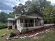 House with a front porch, American flag, and landscaping with rocks at 3246 Wallace Lake Rd, Douglasville, GA 30135