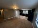 Open kitchen with dark wood cabinets, black appliances, and tile flooring at 3246 Wallace Lake Rd, Douglasville, GA 30135