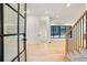 Bright and airy entryway with modern glass door and hardwood floors at 1240 Spalding Dr, Sandy Springs, GA 30350