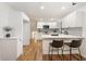 Modern white kitchen with stainless steel appliances and hardwood floors at 3309 W Stewarts Mill Rd, Douglasville, GA 30135