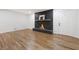 Living room with hardwood floors and a modern black brick fireplace at 3309 W Stewarts Mill Rd, Douglasville, GA 30135