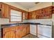 Kitchen with wood cabinets, gas stove and laminate countertops at 1815 Windsor Sw Dr, Atlanta, GA 30311