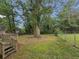 Large backyard with mature trees and a fenced area at 2103 Mcafee Rd, Decatur, GA 30032