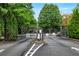 Gated entrance to community with lush landscaping and secured access at 2700 Pine Tree Ne Rd # 2215, Atlanta, GA 30324