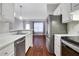 Open concept kitchen with stainless steel appliances and white cabinets at 2700 Pine Tree Ne Rd # 2215, Atlanta, GA 30324