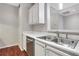 White kitchen cabinets, stainless steel sink and appliances, hardwood floors at 2700 Pine Tree Ne Rd # 2215, Atlanta, GA 30324