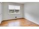 Simple bedroom with hardwood floors and a large window at 1083 Amelia Sw Dr, Marietta, GA 30060