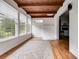 Bright sunroom with wood beamed ceiling, windows, and hardwood floors at 1083 Amelia Sw Dr, Marietta, GA 30060