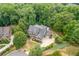 Luxury home nestled in a wooded lot with a large driveway at 2425 Wayward Run, Cumming, GA 30041