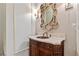 Stylish powder room with marble vanity and decorative mirror at 2425 Wayward Run, Cumming, GA 30041