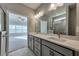 Double vanity bathroom with quartz countertops and a large mirror at 2678 Songbird Ln, Grayson, GA 30017