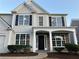 Two-story house with gray siding, stone accents, and a covered porch at 681 Courageous Ct, Lawrenceville, GA 30043