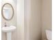 Small bathroom with pedestal sink and toilet at 2070 Bonny Glen Cir, Austell, GA 30106