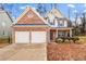 Brick two-story house with a two-car garage and landscaping at 2070 Bonny Glen Cir, Austell, GA 30106