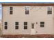 Tan house exterior with multiple windows and a back door at 2070 Bonny Glen Cir, Austell, GA 30106
