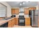 Well-equipped kitchen with wood cabinets and black appliances at 4234 Stillwater Dr, Duluth, GA 30096