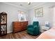 Well-lit bedroom with a dresser, recliner, and large window at 422 Thunder Ridge Dr, Acworth, GA 30101