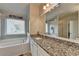 Elegant bathroom with granite vanity and large mirror at 1527 Landmark Ln, Cumming, GA 30040