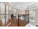 Upstairs hallway with hardwood floors, mirrors, and a view of the main bedroom at 2773 Carillon Xing, Marietta, GA 30066